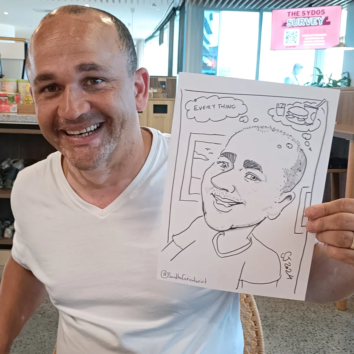 Corporate guest in a white shirt holding up his caricature